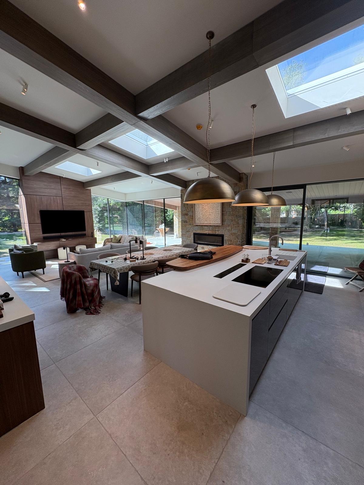 Open-plan kitchen, dining and living space with large-format stone-effect porcelain floor tiles throughout